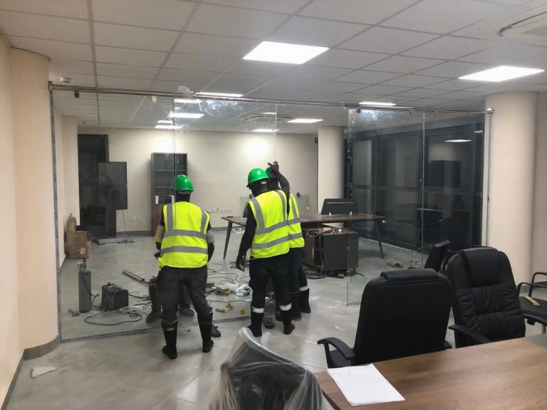 create workers wearing reflective vest, black safety boots and green helmet with (1)